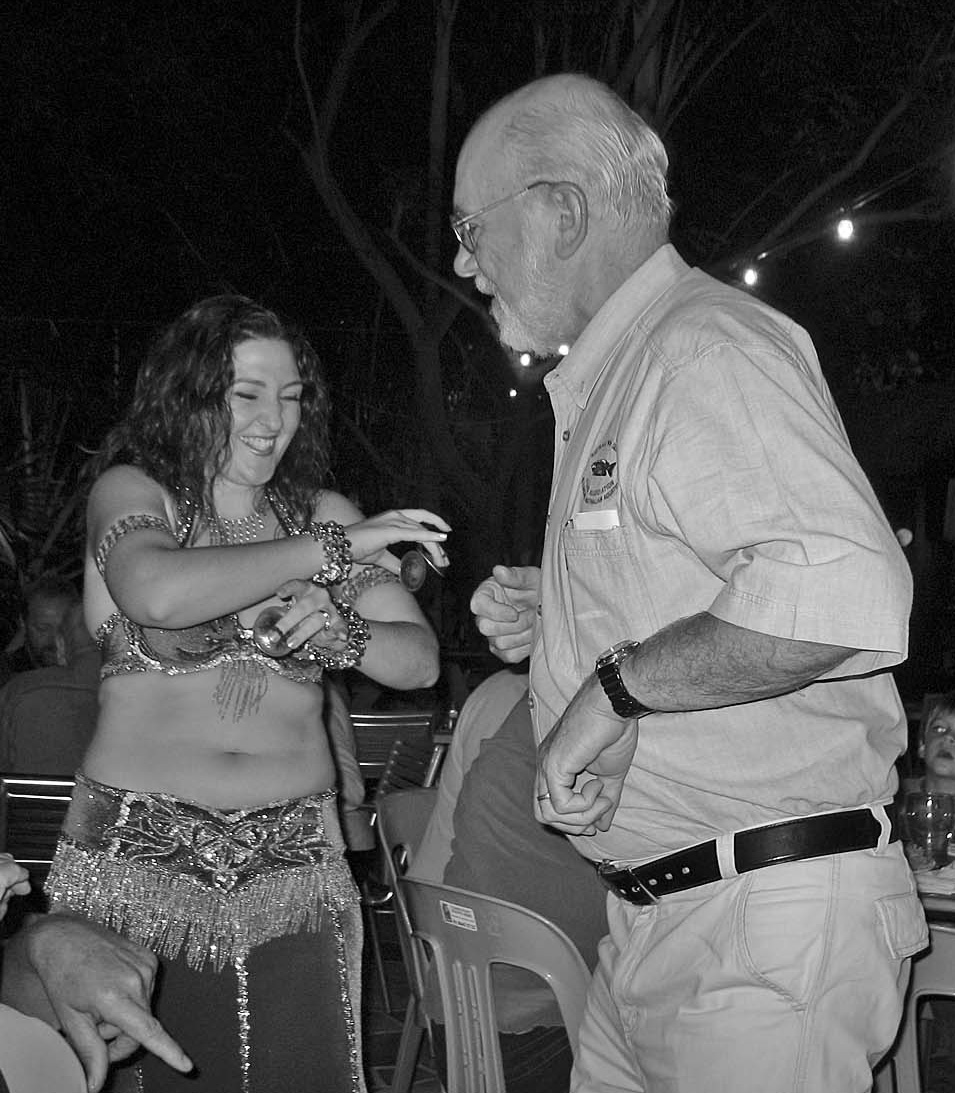 Eddie Tootell dancing with a belly dancer at the Saturday night function