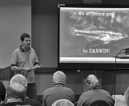 Glenn Briggs welcoming attendees with the ANGFA welcome slide showing a rainbowfish
