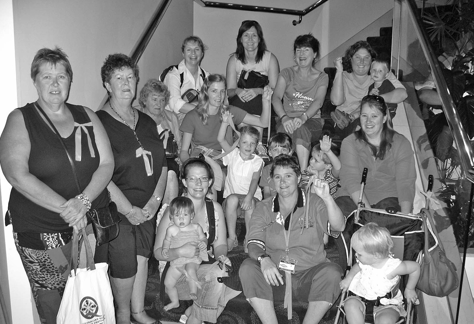 The Fish Widows and families gathered on a staircase before a day out