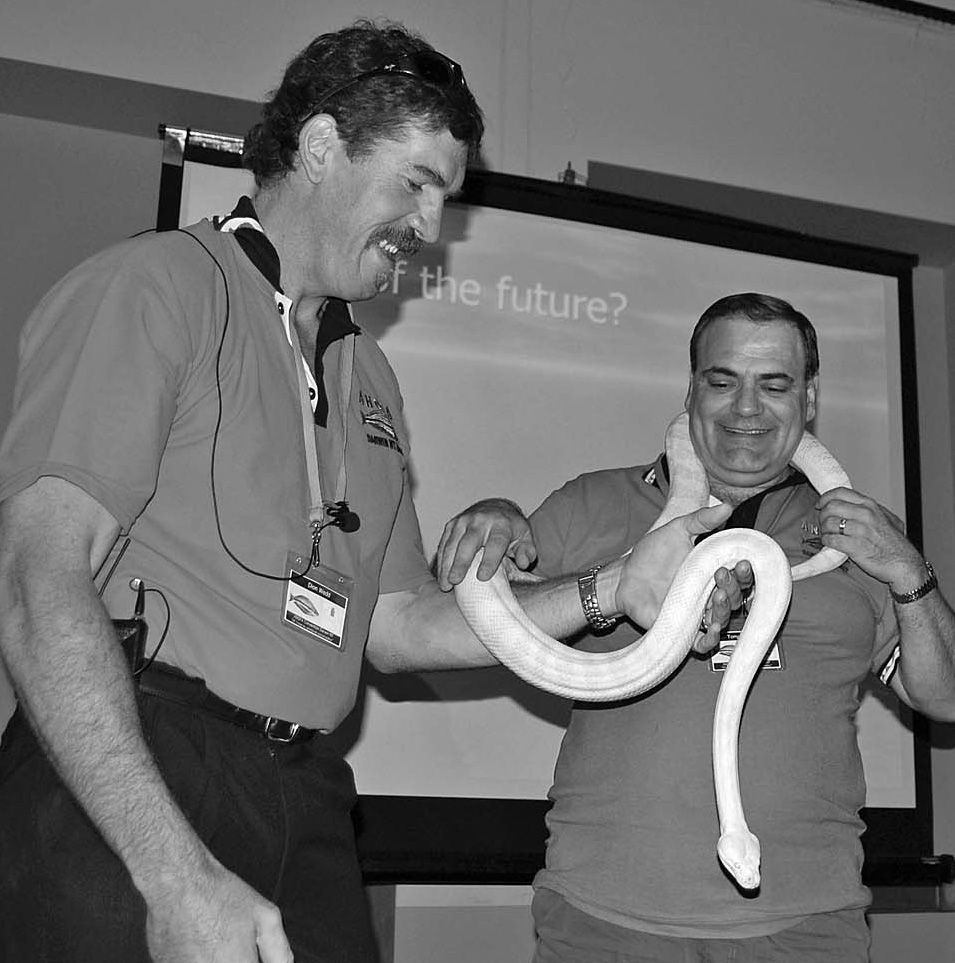 Tony Tucceri holding a large albino carpet python, handed to him by Dion Wedd