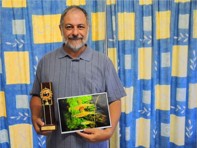Keith Martin holding his winning photograph and trophy