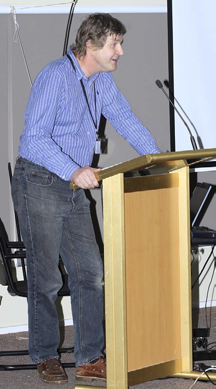 Doug McColl speaking at the podium